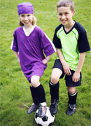 two children playing soccer