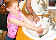 a child washing their hands.