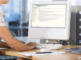 a childcare worker reading an article on the computer.