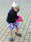 a boy throwing a frisbee.