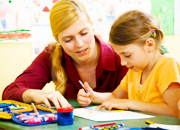 A child care worker observing a child at play