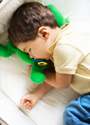 a child sleeping on a mattress on the floor.