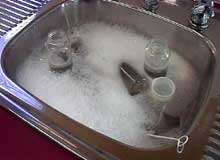 bottles and equipment soaking in the sink.