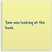 Piece of paper with writing on it saying, 'Sam was looking at the book'.