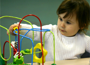 a young child moving small objects with their hand.