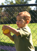 a young child throwing a ball.