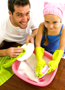 a child washing dishes.