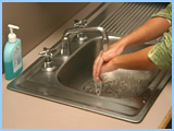 person rinsing their hands.