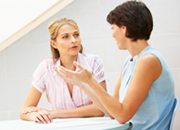 Picture of mother talking to childcare worker.