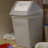 a nappy bin. It has the word nappies written on it in large letters.