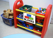 a shelf labelled blocks. It contains tubs full of blocks.