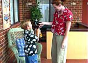 an adult standing close to a child.